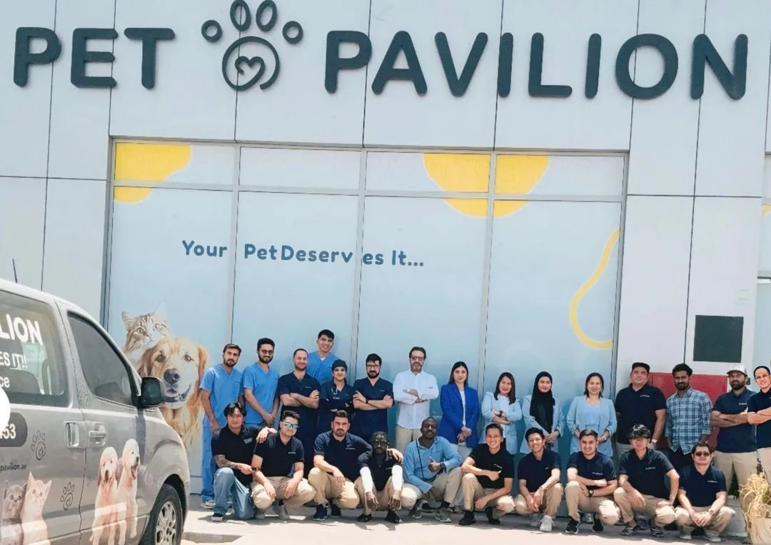 The Pet Pavilion team outside the clinic in Mussafah, beside the Pet Taxi van